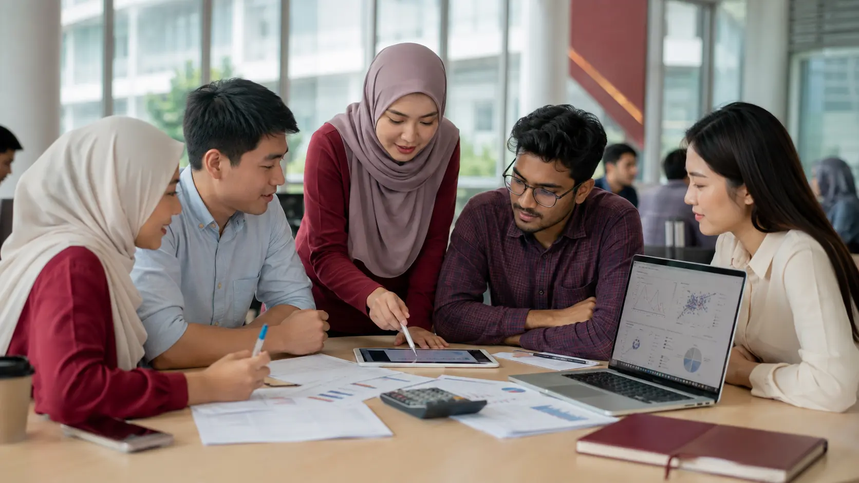 A diverse Malaysian research team planning research methods and analysing data